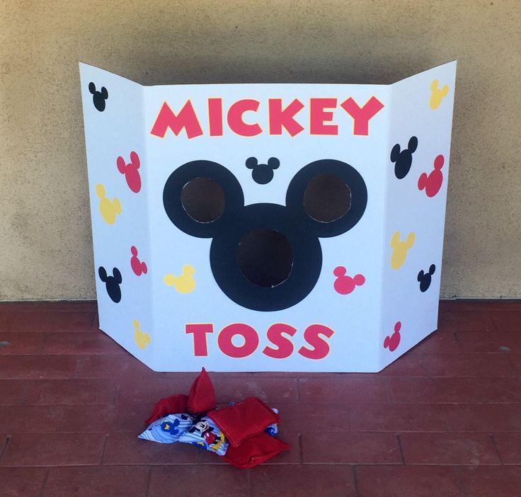 a cardboard box with mickey mouse's nose on it next to a candy bag