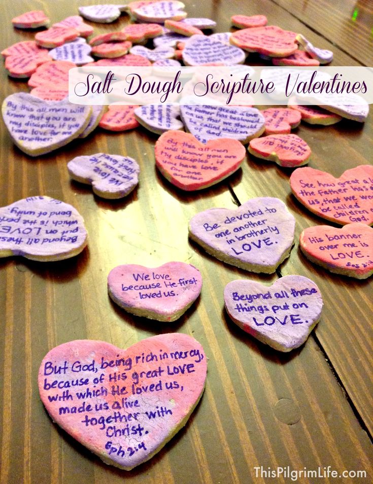 conversation hearts with words written on them sitting on a wooden table in front of the caption that says, salt dough signature valentines