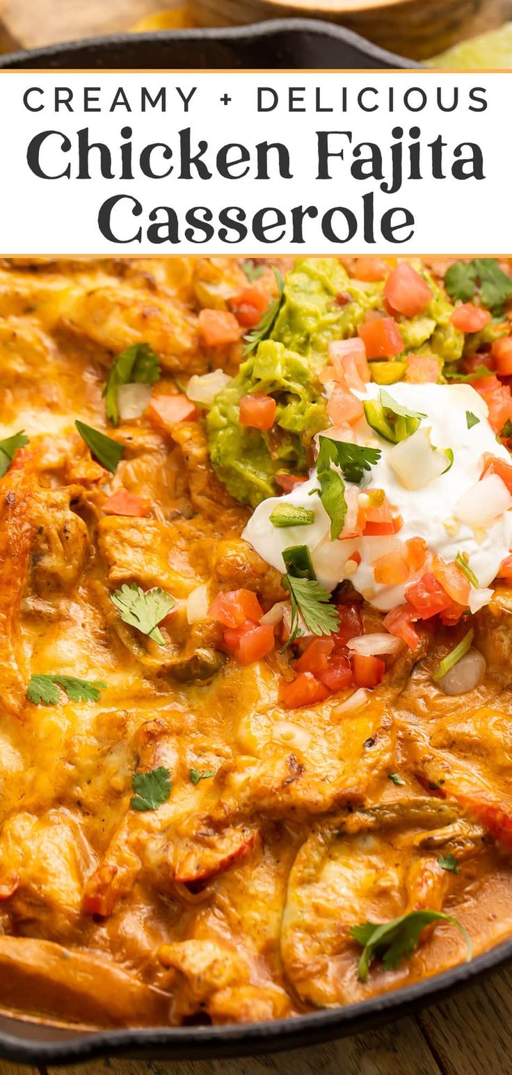 chicken fajita casserole in a skillet topped with guacamole and sour cream