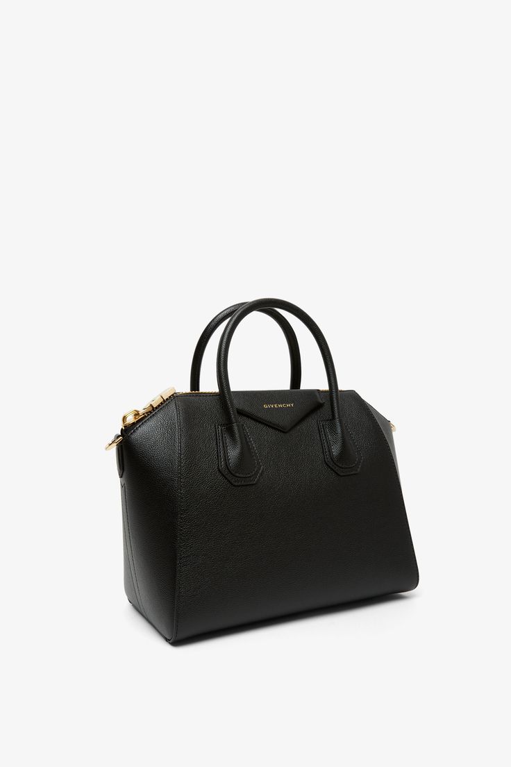 Black leather tote bag from Givenchy. The Antigona small black leather bag is made of smooth black calf leather featuring a zipped top, silver-toned hardware and is complete with a detachable, adjustable shoulder strap.Measurements: L28 x H25 x W15cmMade in Italy Small Black Bag, Black Leather Bag, Black Leather Tote Bag, Black Leather Tote, Black Leather Bags, Black Bag, Leather Tote Bag, Leather Tote, Givenchy