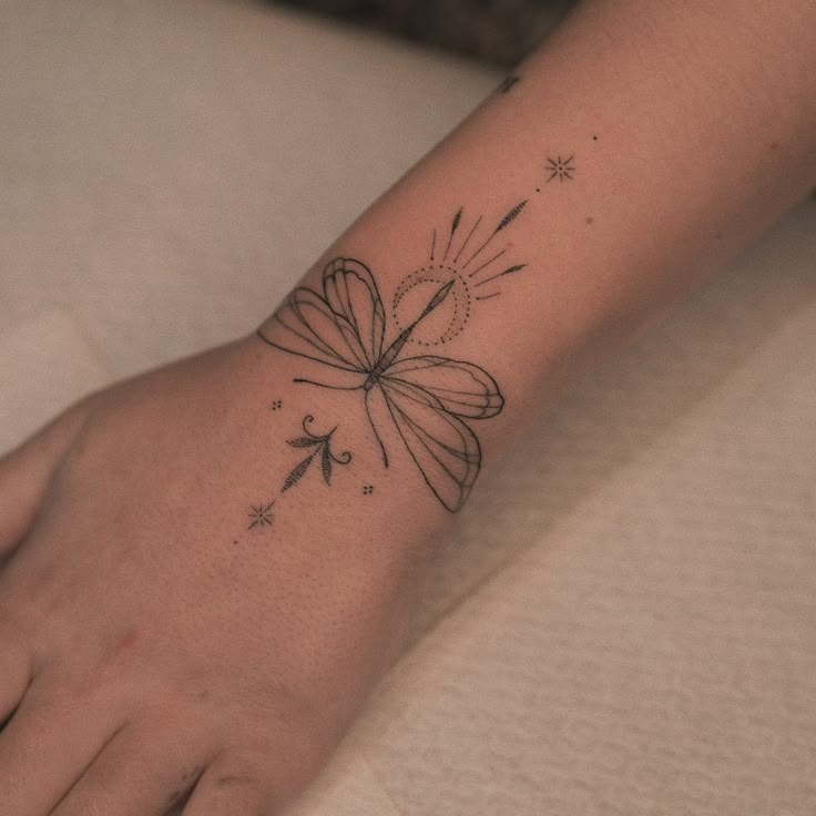 a woman's foot with a butterfly tattoo on the left side of her arm