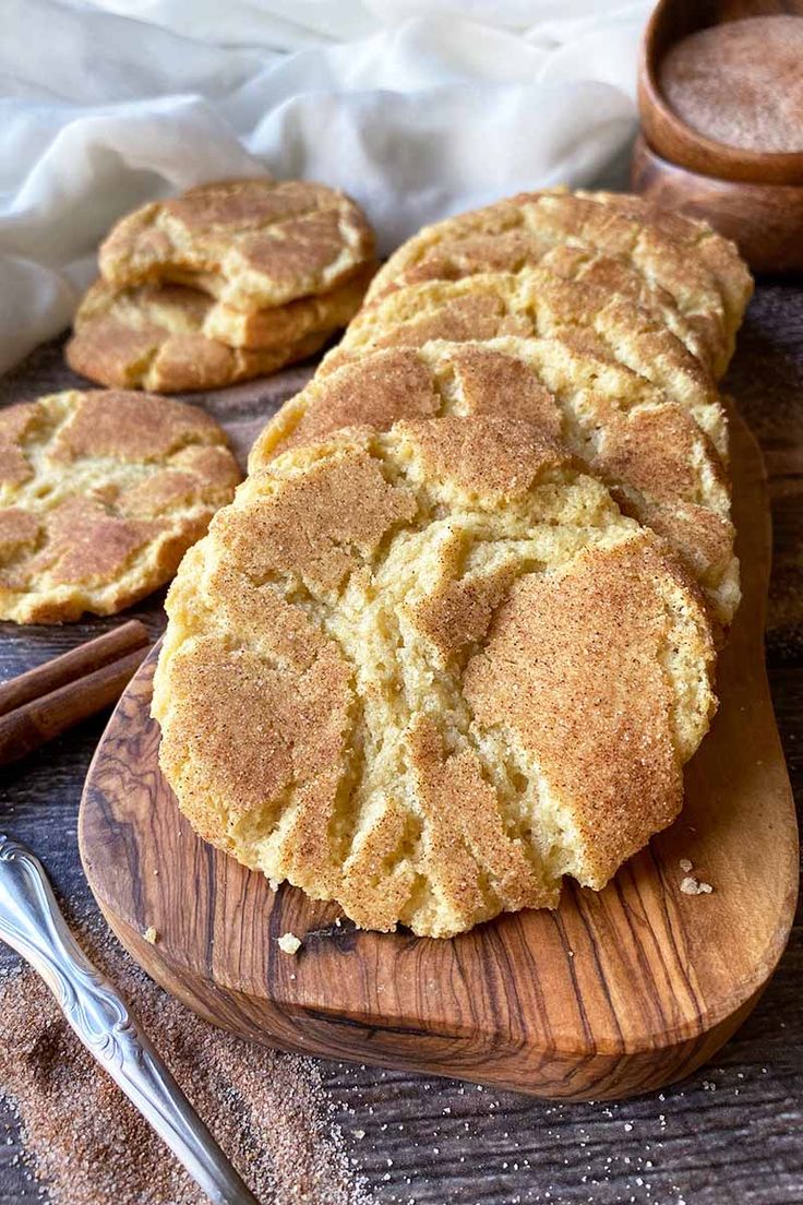 some cookies are on a wooden board with spoons