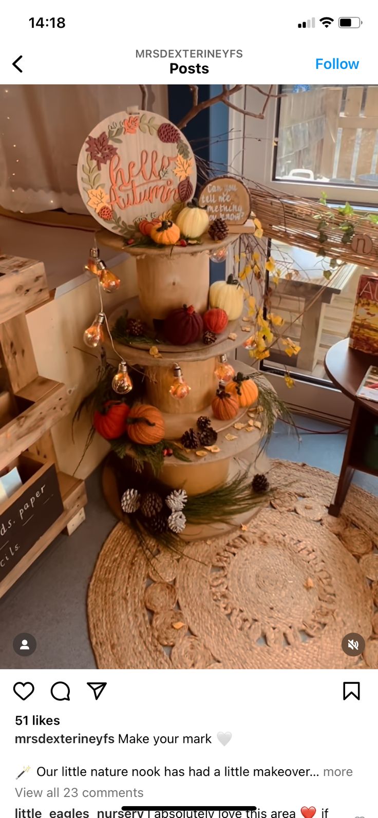 a three tiered cake sitting on top of a table in front of a window