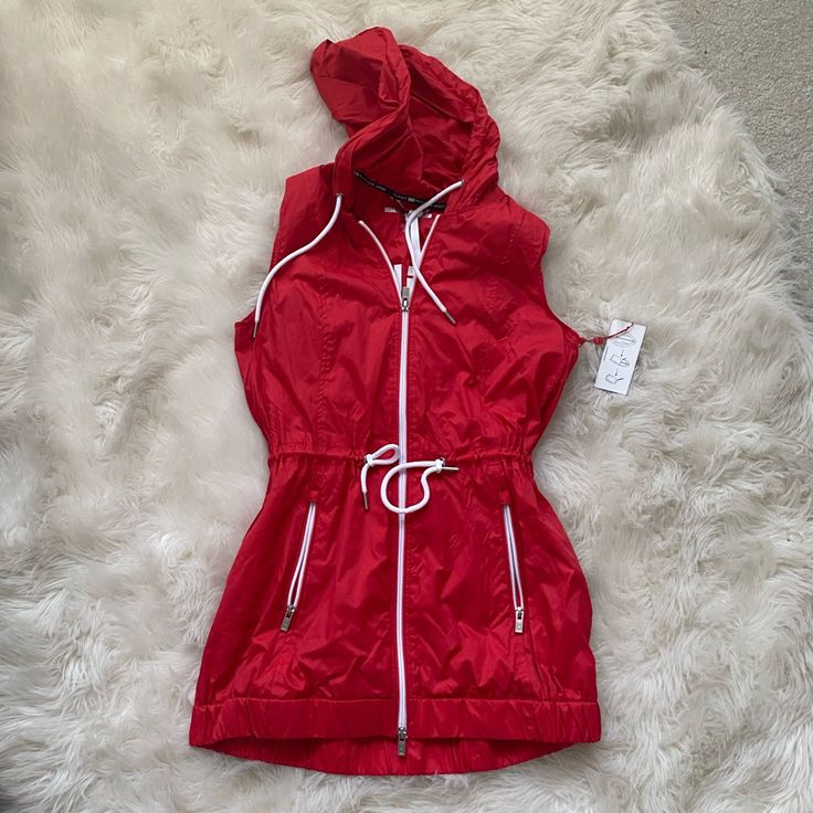 Brand New With Tags Tommy Hilfiger Rain Jacket Vest In Red. Never Worn. Also Comes With A Bag For The Jacket. Tommy Hilfiger Casual Spring Outerwear, Casual Tommy Hilfiger Outerwear For Spring, Red Fitted Nylon Outerwear, Hooded Red Tommy Hilfiger Outerwear, Trendy Red Windbreaker For Fall, Red Spring Windbreaker With Pockets, Red Spring Outerwear With Pockets, Red Hooded Outerwear For Spring, Trendy Red Fall Windbreaker