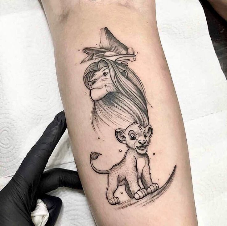 a woman's leg with a lion and a witch hat on top of it