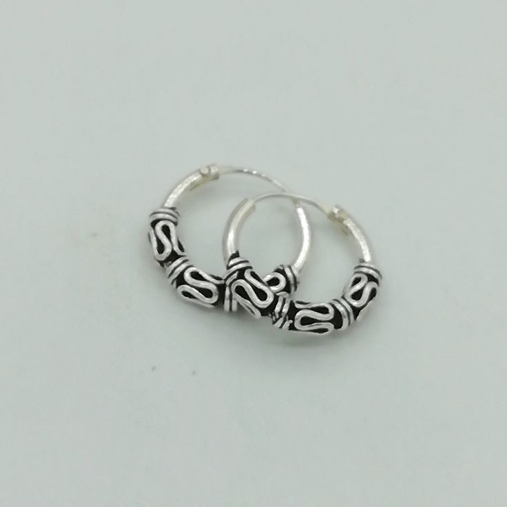 Bali style sterling silver ear hoops with silver wire work. Dimensions: 1.5 x 14 mm Price listed is for a PAIR of hoops. These earrings are made of 925 hypoallergenic sterling silver and comes with a 925 stamp. Can be packaged in a gift box. I can include a personal message from you if needed You are welcome to contact me at... bhavnakwintra1956@gmail.com For more beautiful pieces from my shop, please browse 👇 TOE RINGS: https://www.etsy.com/your/shops/TheSilverGame/tools/listings/section:27020 Nickel Free Small Hoop Sterling Silver Piercings, Nickel-free Small Hoop Sterling Silver Piercings, Sterling Silver Small Hoop Septum Ring, Silver Huggie Pierced Nose Rings, Silver Huggie Nose Rings, Nickel-free Small Hoop Cartilage Earrings, Small Hoop Sterling Silver Nose Rings, Nickel-free Small Hoop Sterling Silver Septum Ring, Nickel-free Small Hoop Septum Ring In Sterling Silver