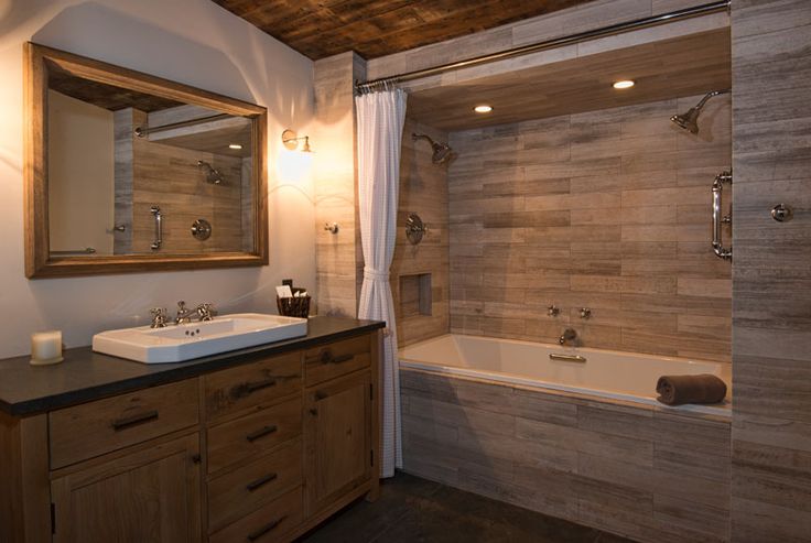 a bathroom with a sink, mirror and bathtub