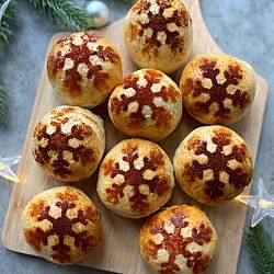 a wooden board topped with muffins covered in icing