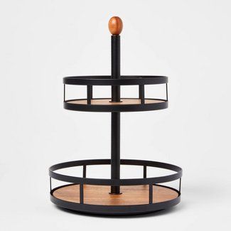 three tiered tray with an orange ball on top and black metal frame around it