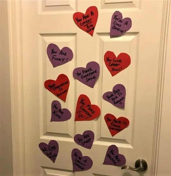 the door is decorated with hearts and messages