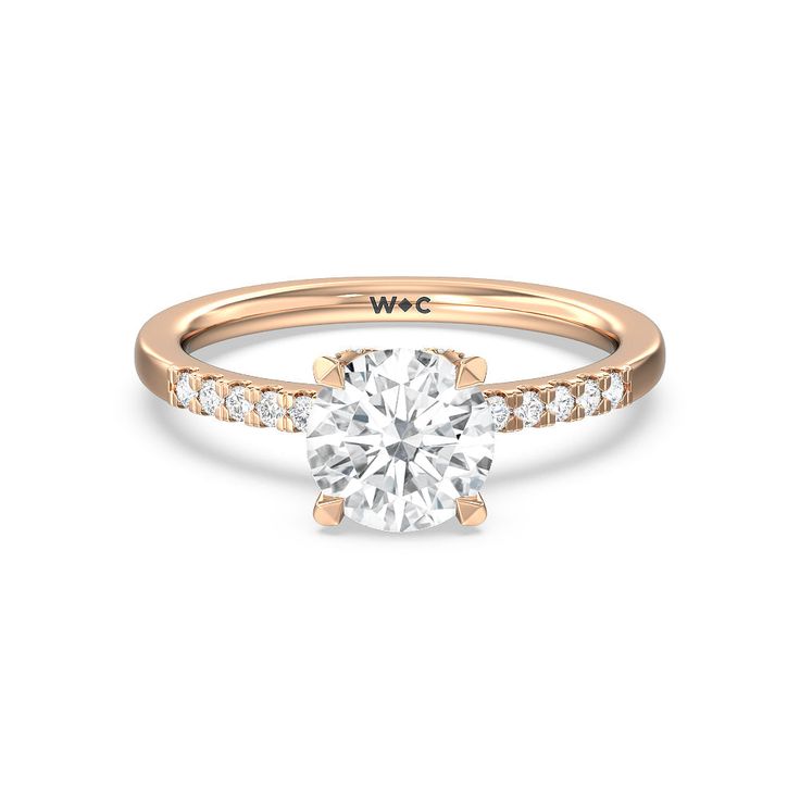 a rose gold engagement ring with diamonds on the side