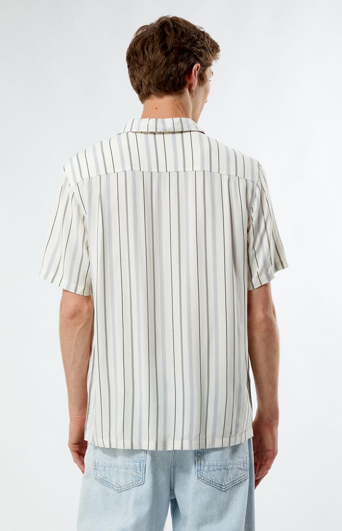 The PacSun Striped Camp Shirt from PacSun is your ticket to easygoing sophistication. Elevate your style with its classic collared neckline and short sleeves, perfect for those sunny days ahead. Crafted from lightweight fabric and eye-catching stripes, it's the ultimate blend of comfort and charm for your summer adventures.


	Collared neckline
	Short sleeves
	Standard fit
	Button closures
	Custom pattern
	100% Rayon
	Machine washable
	Model is wearing size medium
	Model Measurements: 6'1.5” Height, 28” Waist, 32” Inseam Classic Camp Collar Tops For Beach, Classic Beach Tops With Camp Collar, White Collared Shirt For Summer, Summer Camp Shirt With Johnny Collar And Placket, Casual Striped Camp Shirt With Camp Collar, Summer Camp Shirt With Collared Neckline, Summer Camp Shirt With Johnny Collar, Summer Striped Shirt With Spread Collar, Casual White Johnny Collar Short Sleeve Shirt