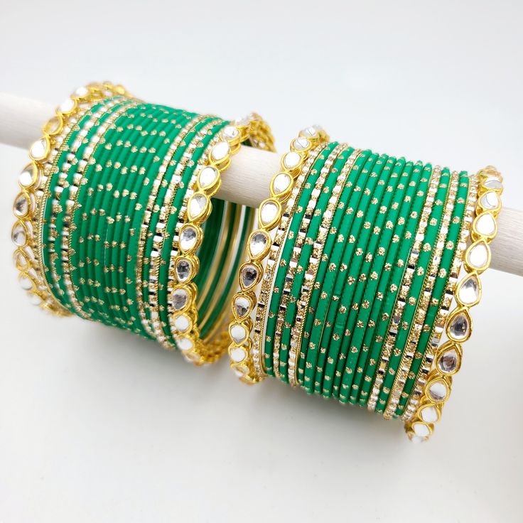 Bangle set comes with 2 sets - 1 per arm. Feel free to mix and match on your own! Step into a world of timeless elegance with our exquisite Kundan gold-plated bangle set, adorned with matte green and accentuated by dazzling gold glitter and gold bangles featuring intricate Kundan work that showcases the intricate beauty of traditional Indian craftsmanship. The bright green adds a vibrant pop to your ensemble, while the gold bangles provide a touch of opulence and sophistication. Love the fusion Luxury Multicolor Formal Bangle, Luxury Green Hand Set Chandbalis, Green Bangle Bracelets For Wedding, Adjustable Green Bangle For Wedding, Adjustable Green Wedding Bangle, Adjustable Green Bangle For Party, Festive Green Bangle As Gift, Elegant Green Bracelets For Festive Occasions, Festive Green Bangle For Gift