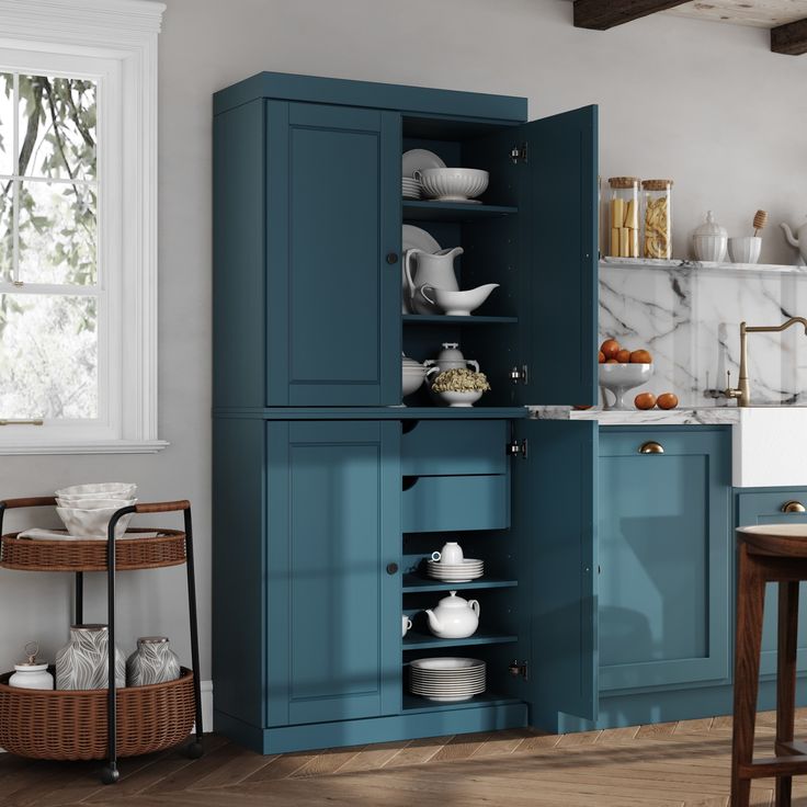 a kitchen with blue cabinets and white dishes