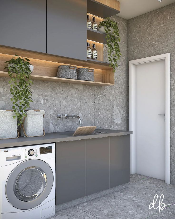 a washer and dryer in a room with shelves above the sink, next to an open door