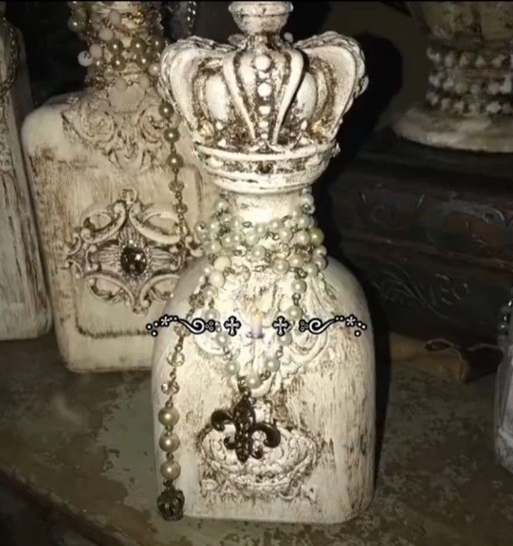 three white vases sitting on top of a table