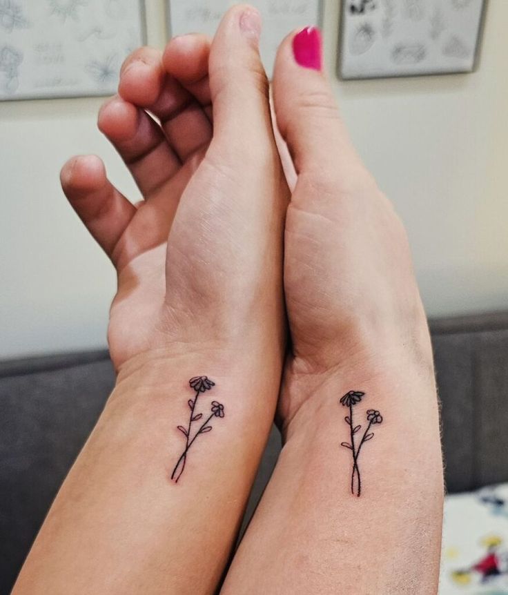 two people with matching tattoos on their arms