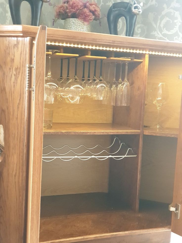 a wooden cabinet with wine glasses on it