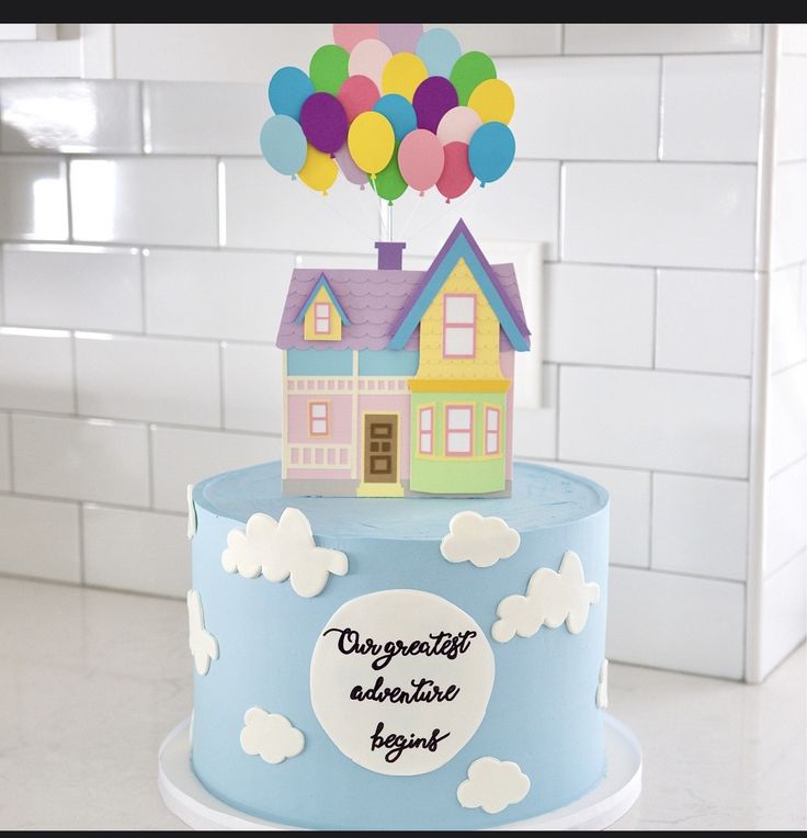 a birthday cake with a house and balloons on top