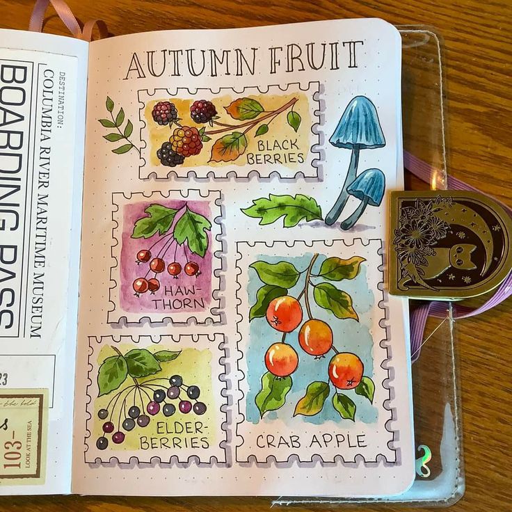 an open book with stamps on it sitting on top of a wooden table next to a rubber stamp