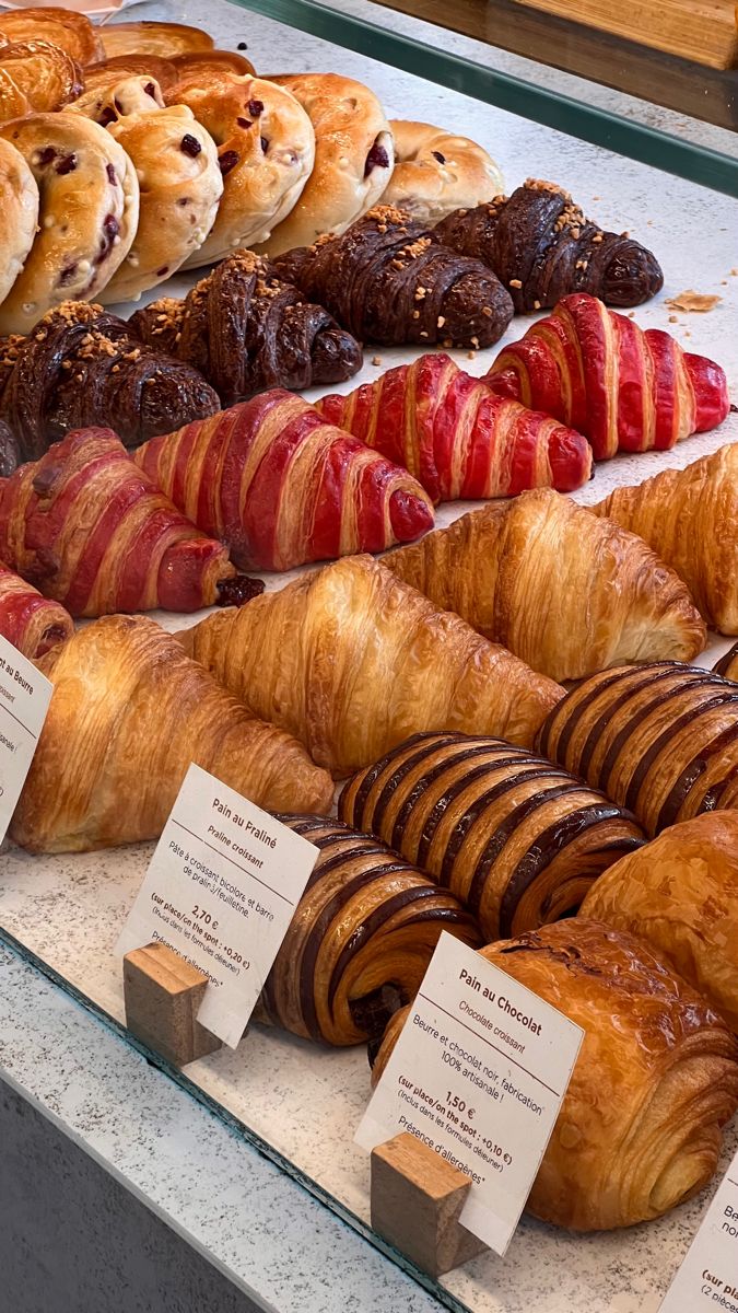 many different types of croissants and pastries on display