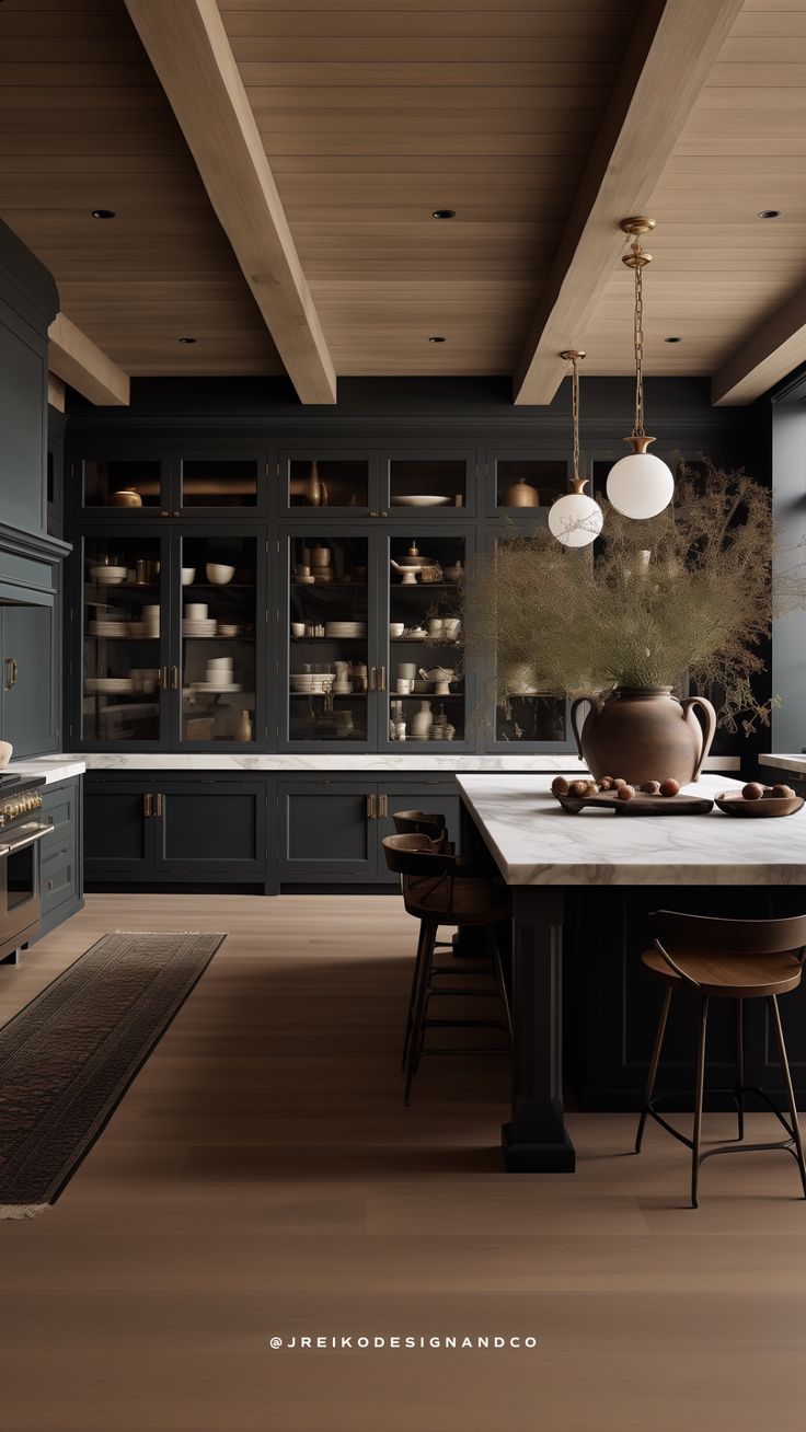 a kitchen with wooden floors and dark blue cabinets is pictured in this image, there are two stools at the center of the table