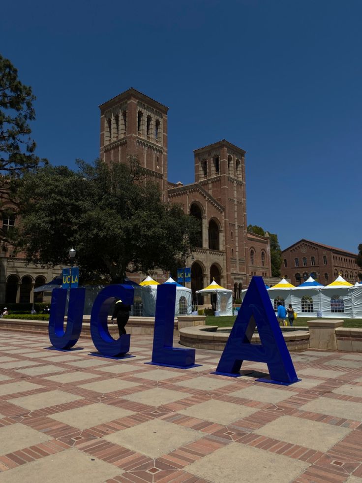 large letters that spell out the word usa are in front of a building and trees