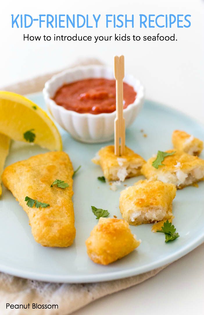 a white plate topped with food next to a lemon wedge and ketchup on a stick