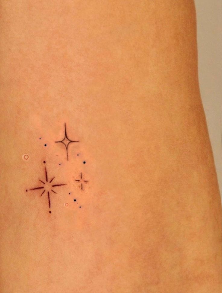 a small star tattoo on the back of a woman's stomach