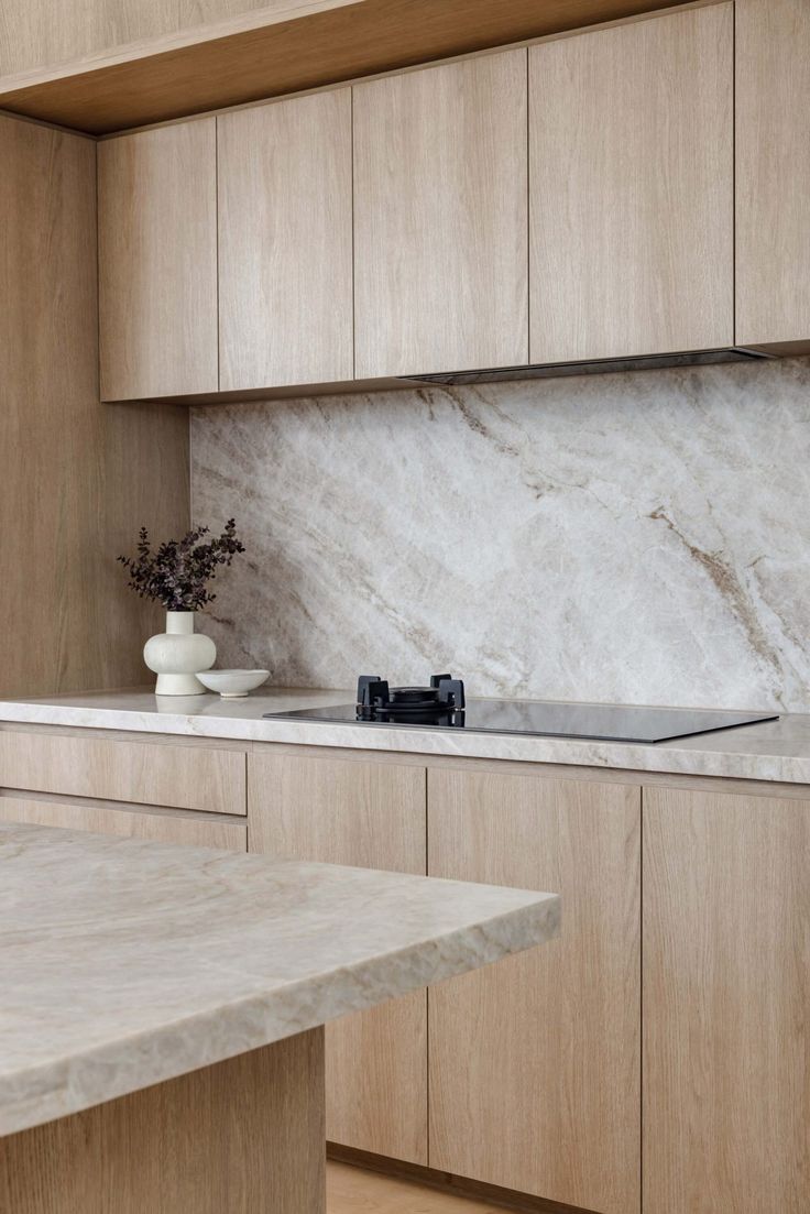 a kitchen with marble counter tops and wooden cabinets