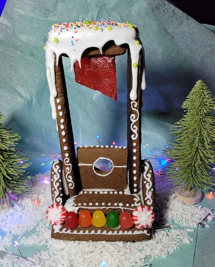 a gingerbread house made to look like it is coming out of the snow covered ground