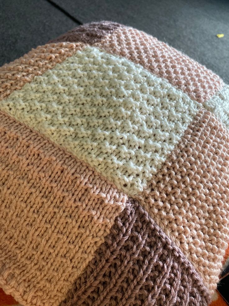 a knitted beanie sitting on top of an orange table