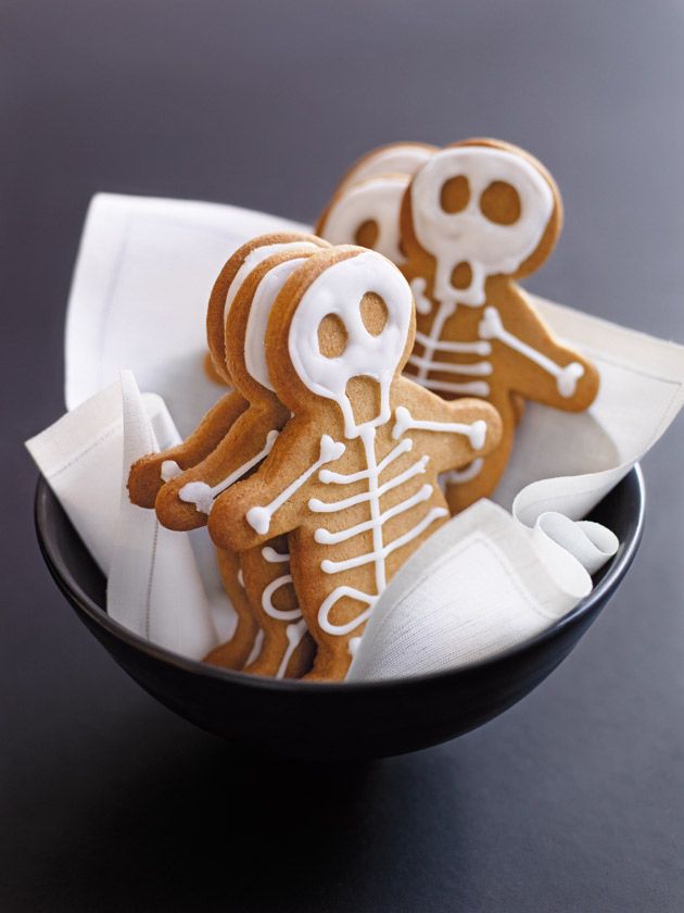 three decorated cookies in a bowl on a table