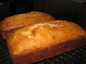 two loaves of bread cooling on a rack