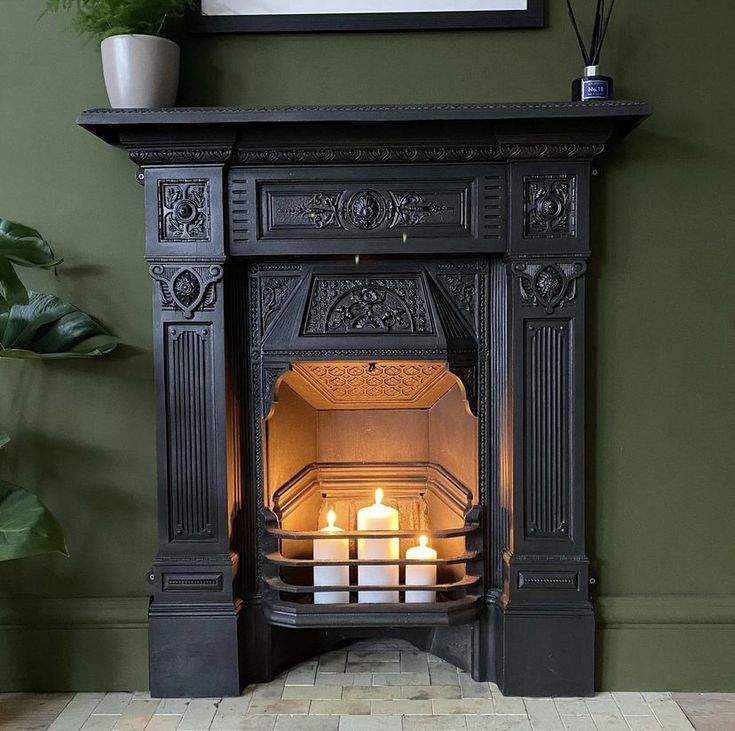 an ornate fireplace with lit candles in it