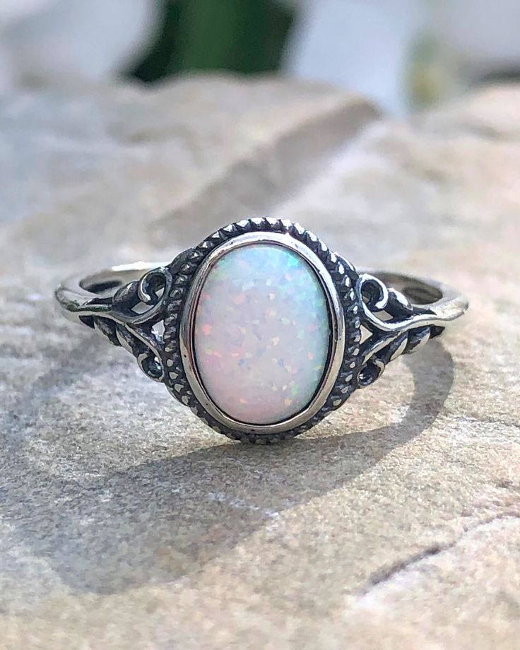 Sterling Silver Oval White Lab Opal Ring | The Life Divine Sterling Silver Oval White Lab Opal RingCherished for its brilliance, Opal is known as a stone of creativity and vitality. Opal is also a reflective stone of protection, absorbing energies and sending them back to their source.Measures approximately 3/8" H x 1/2" W Adjustable White Oval Crystal Ring, Adjustable Opal Crystal Ring, Oval Shape, Adjustable Opal Oval Crystal Ring, Adjustable Oval Opal Crystal Ring, Spiritual Oval Opal Birthstone Ring, White Oval Opal Crystal Ring, Spiritual Oval Crystal Ring With Large Stone, White Oval Spiritual Jewelry, Adjustable Oval Cabochon Crystal Ring