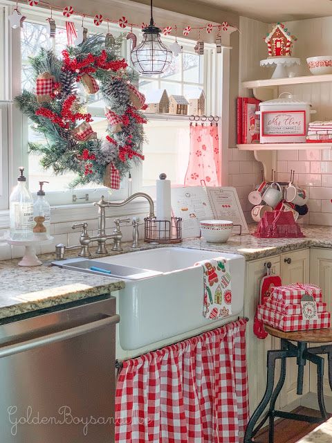 a kitchen decorated for christmas with red and white decor