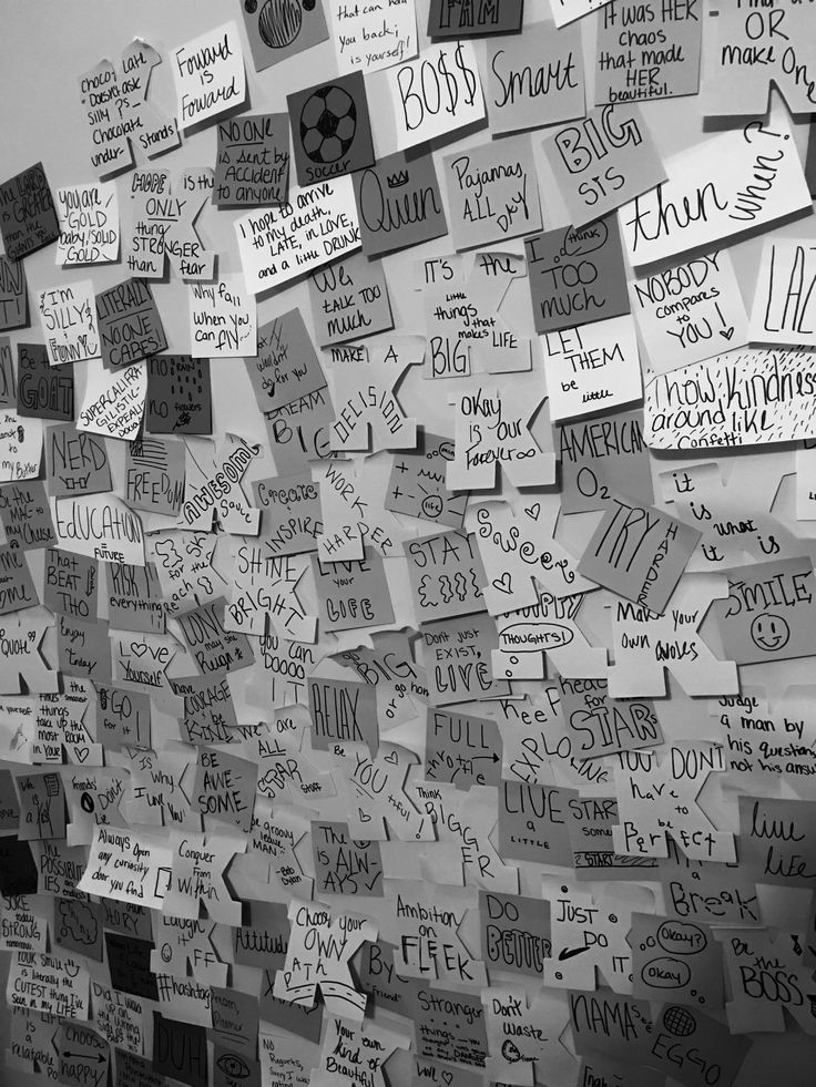 a wall covered in lots of writing and notes