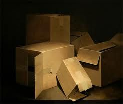 several cardboard boxes stacked on top of each other in the middle of a dark room