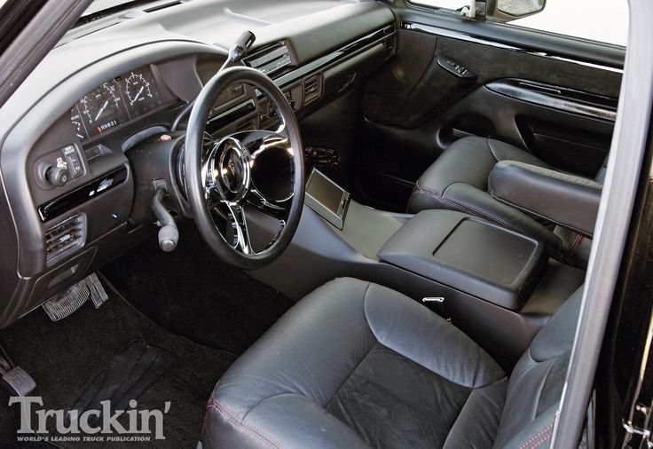 the interior of a car with black leather seats