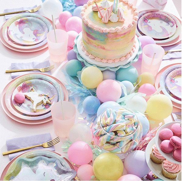 a table topped with lots of plates and cake