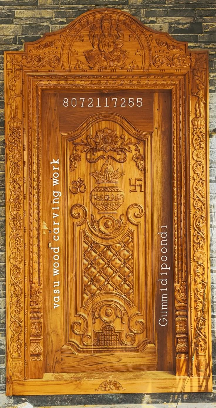 a wooden door with carvings and numbers on it