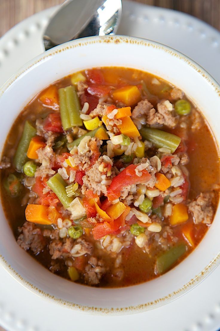 a white bowl filled with soup on top of a wooden table