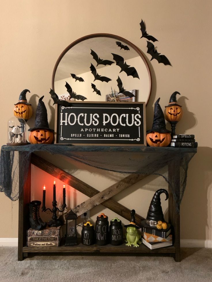 a table with halloween decorations on it and a sign that says hoccus docus