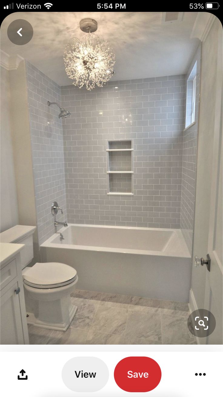 the bathroom is white and has gray tile on the walls, floor, and ceiling