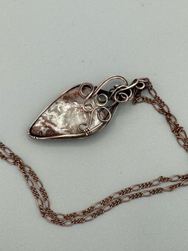 Beautiful Crazy Lace stone wire wrapped in oxidized copper wire to give it an antique look. Features square wire twisted into swirls to make a lovely design at the top. Pendant is 2.25 inches tall and 1 inch wide. Comes with a free chain! Beautiful Crazy, Oxidized Copper, Wrapped Pendant, Jewelry Maker, Wire Wrapped Pendant, Copper Jewelry, Copper Wire, Wire Jewelry, Wire Wrapped