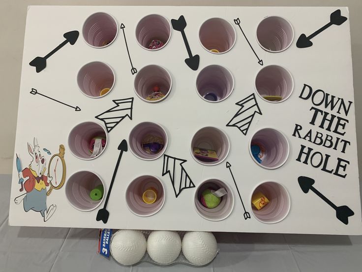 an odd looking board game with many cups and balls on it's back side