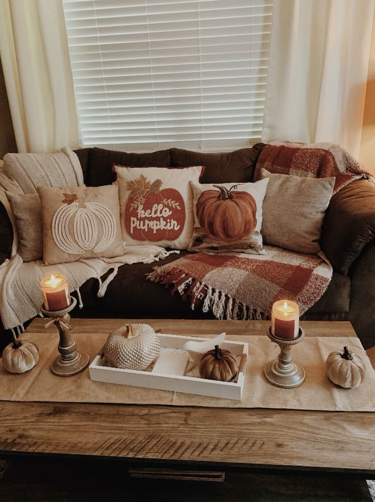 a living room filled with furniture and candles