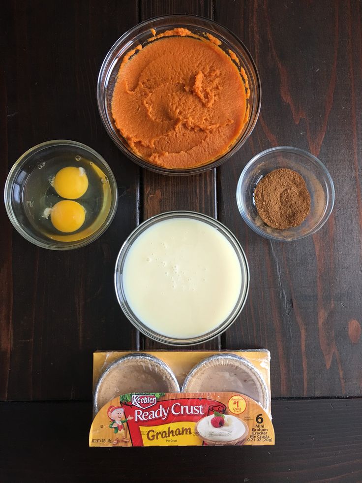 the ingredients to make an orange cake are shown in bowls on a wooden table top