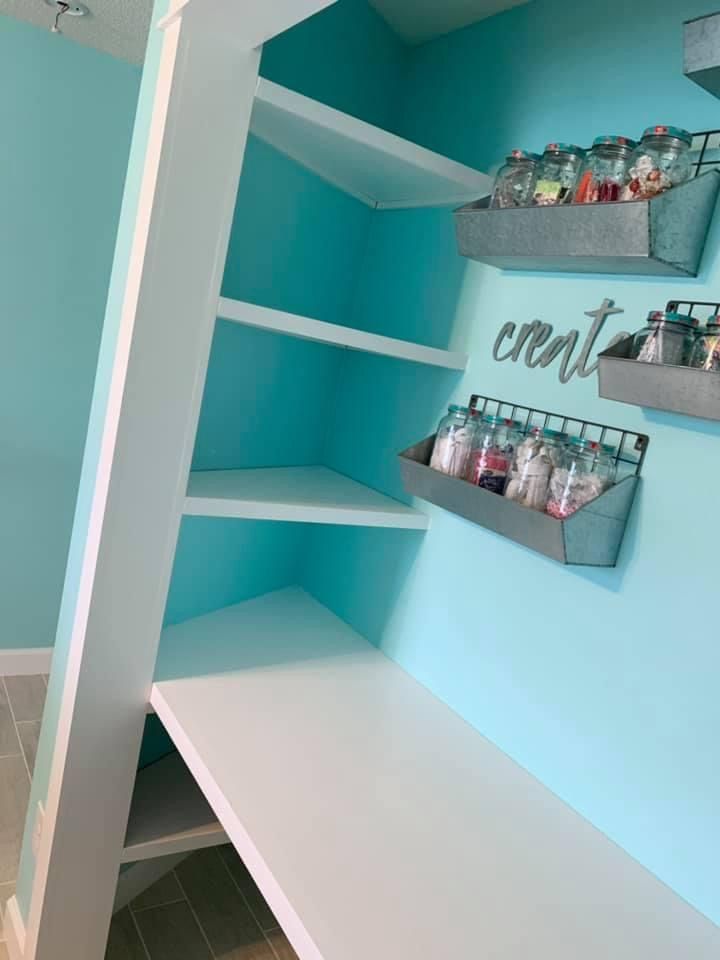 the shelves in this bathroom are filled with bottles